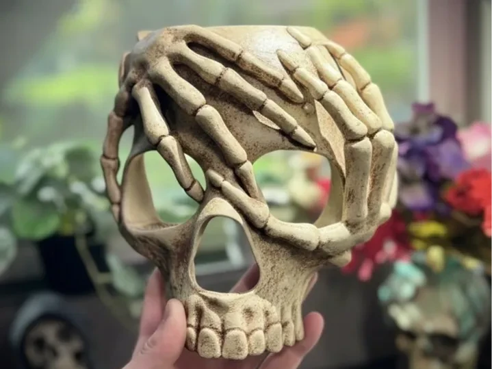 Máscara de calavera con manos de esqueleto
